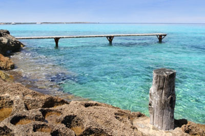 Formentera Illetes turquoise sea wooden pier aged trunk Illetas